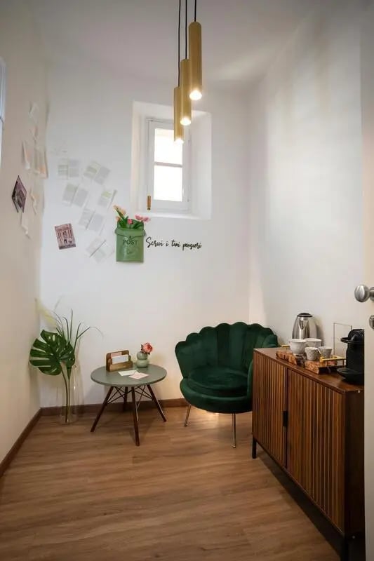 Green armchair small table coffee maker common area at 1-Bedroom apartment near the Pescara Centrale in Pescara Student Accommodation