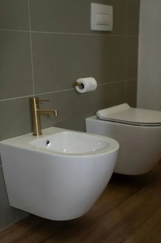 Modern bidet toilet paper and flush mechanism bathroom at 1-Bedroom apartment near the Pescara Centrale in Pescara Student Accommodation