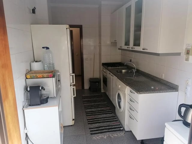 Refrigerator microwave coffee maker stove sink washing machine kitchen at Cozy Single Bedroom close to Lavandeira Park in Vila Nova De Gaia Student Accommodation
