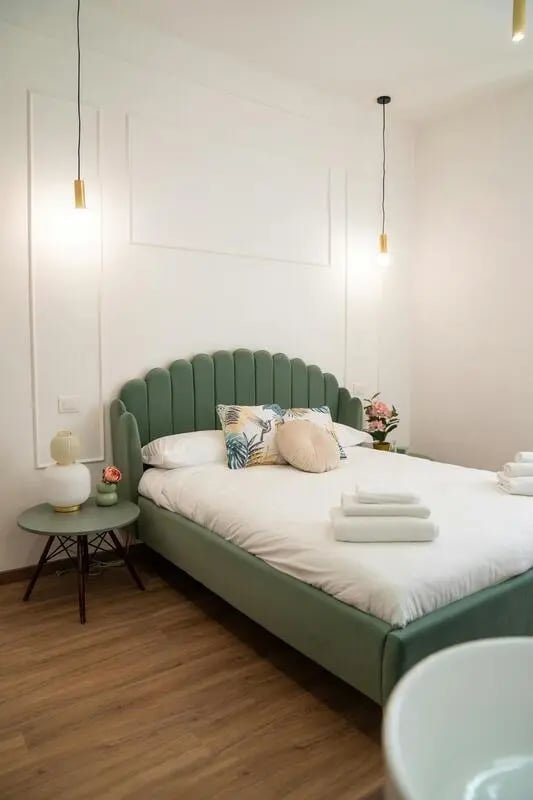 Green bed with white bedding and pillows Bedroom at 1-Bedroom apartment near the Pescara Centrale in Pescara Student Accommodation