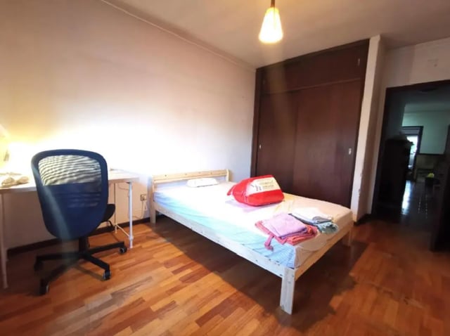 Bed desk chair red pillow towels bedroom at Double Bedroom close to Minho University 3 in Guimaraes Student Accommodation