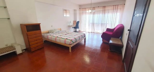 Bed dresser desk chair sofa living room bedroom at Double Bedroom close to Minho University 3 in Guimaraes Student Accommodation