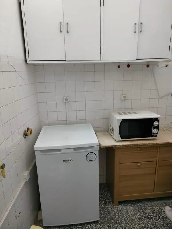 White fridge microwave white cabinets kitchen at Nice double bedroom in Ponte de Lima in Viana Do Castelo Student Accommodation