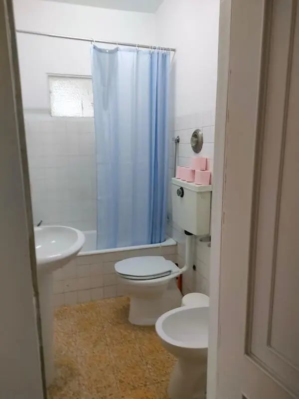 Sink toilet bidet blue shower curtain bathroom at Nice double bedroom in Ponte de Lima in Viana Do Castelo Student Accommodation