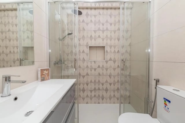 Modern sink toilet and shower with glass enclosure Bathroom at Neat 2-bedroom flat in Olhão in Faro Student Accommodation