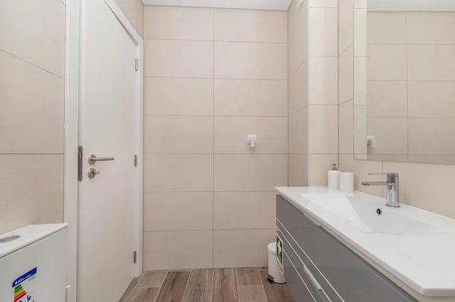 White door sink vanity mirror and toilet bathroom at Neat 2-bedroom flat in Olhão in Faro Student Accommodation