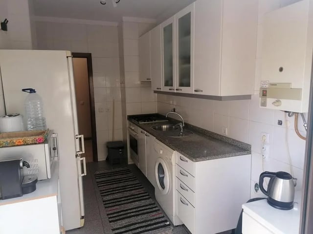 Refrigerator microwave kettle cabinets stove sink kitchen at Classic Single Bedroom close to João de Deus Metro Station in Vila Nova De Gaia Student Accommodation