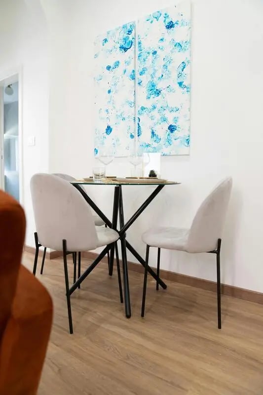 Glass dining table and chairs dining area at Excellent 1-bedroom apartment near Pescara Centrale in Pescara Student Accommodation