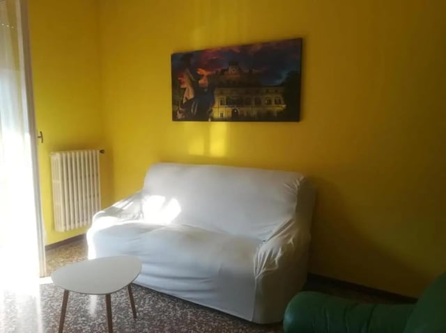 White sofa small table painting living room at Comfy 2 bedroom apartment close to Palazzo Ducale in Parma Student Accommodation