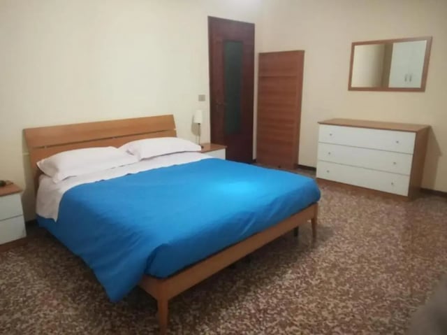 Bed dresser mirror and wardrobe bedroom at Comfy 2 bedroom apartment close to Palazzo Ducale in Parma Student Accommodation