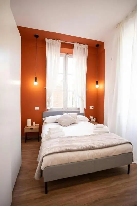 Bed with white linens grey frame bedside table bedroom at Excellent 1-bedroom apartment near Pescara Centrale in Pescara Student Accommodation