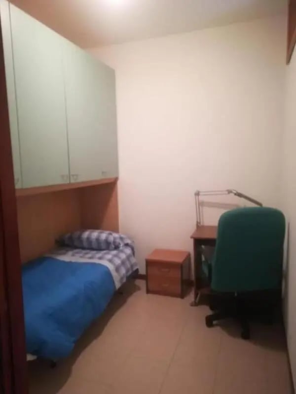 Bed desk chair cabinets bedroom at Comfy 2 bedroom apartment close to Palazzo Ducale in Parma Student Accommodation