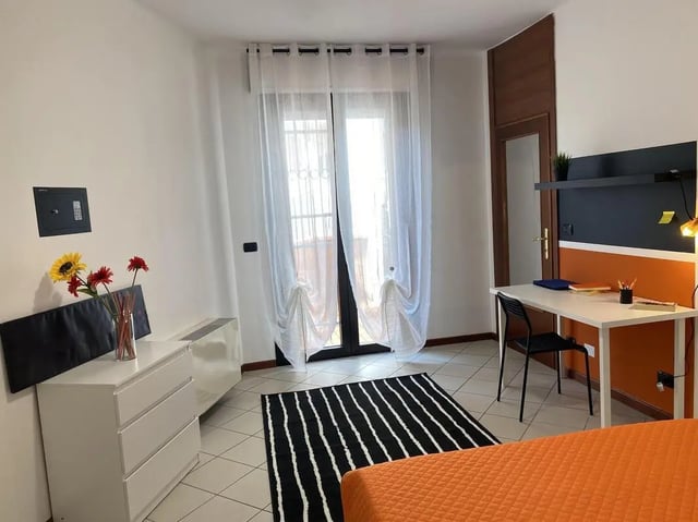 Safe drawers desk chair curtains and bed study area at Welcoming double bedroom in a student flat, in the centre of Pescara in Pescara Student Accommodation