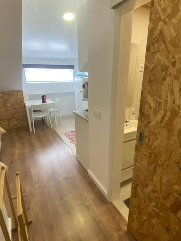 Dining table chairs kitchen sink bathroom interior at Welcoming Studio close to Viana do Castelo Center/Train Station in Viana Do Castelo Student Accommodation