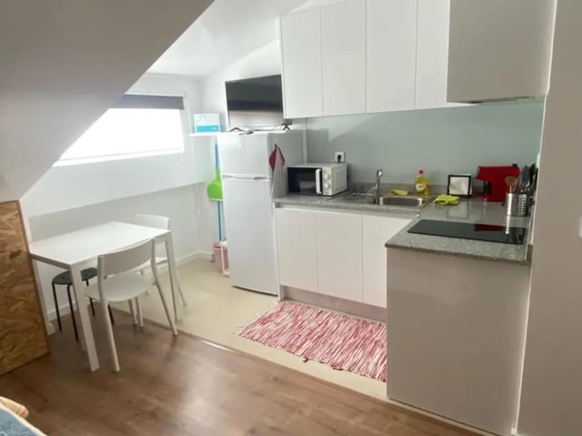 Table chairs fridge microwave sink kitchen living area at Welcoming Studio close to Viana do Castelo Center/Train Station in Viana Do Castelo Student Accommodation