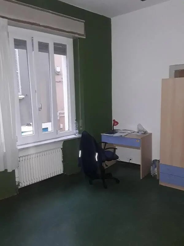 Desk chair radiator wardrobe study area at Single Bedroom in a 4 bedroom apartment in Parma in Parma Student Accommodation