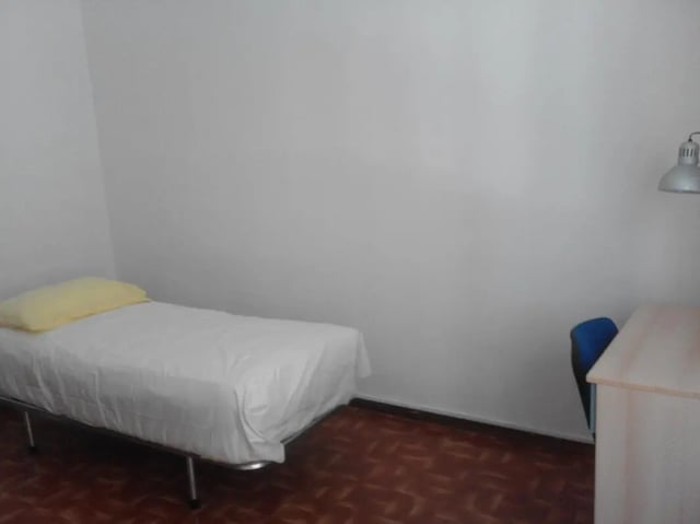 Bed with yellow pillow desk and chair bedroom at Single Bedroom in a 4 bedroom apartment in Parma in Parma Student Accommodation