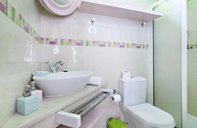 Sink toilet soap dispenser towel rack bathroom at Sunny and lovely 1-bedroom flat in Faro Student Accommodation