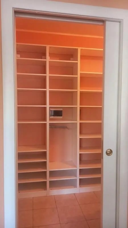 Empty white shelves and hanging rod closet area at Comfy 3 bedroom apartment close to University of Parma in Parma Student Accommodation