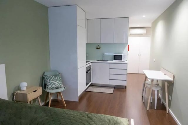 Compact studio with kitchenette and dining area studio apartment at Elegant and functional studio in the historic center of Guimarães in Guimaraes Student Accommodation
