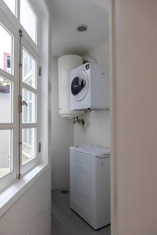 Compact washing machine and dryer laundry area at Elegant and functional studio in the historic center of Guimarães in Guimaraes Student Accommodation