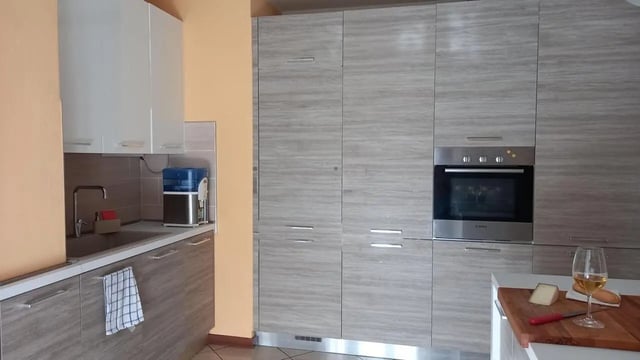 Modern kitchen with sink oven and cabinets kitchen at Comfy 3 bedroom apartment close to University of Parma in Parma Student Accommodation