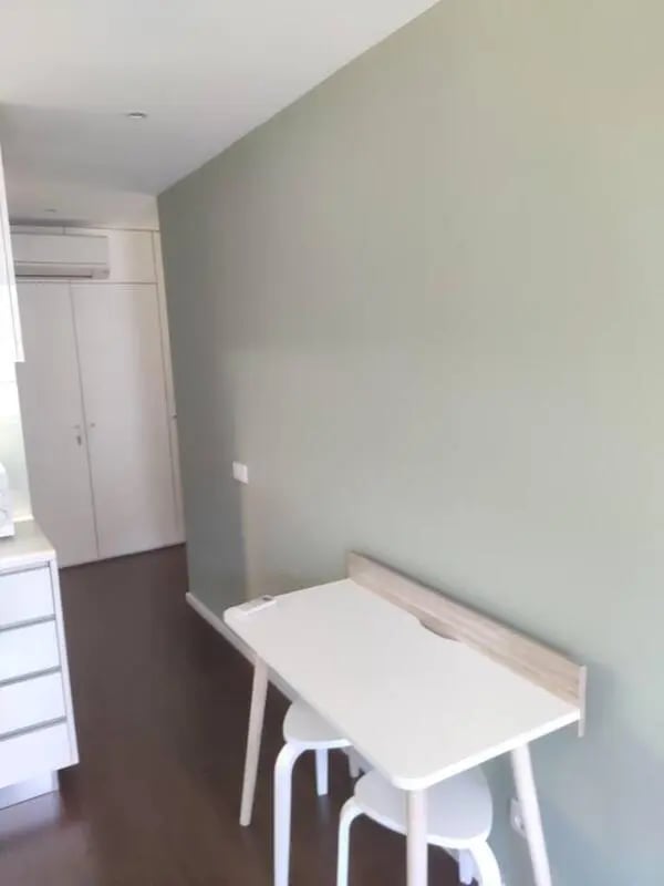 White desk with two stools and cabinets Study area at Elegant and functional studio in the historic center of Guimarães in Guimaraes Student Accommodation