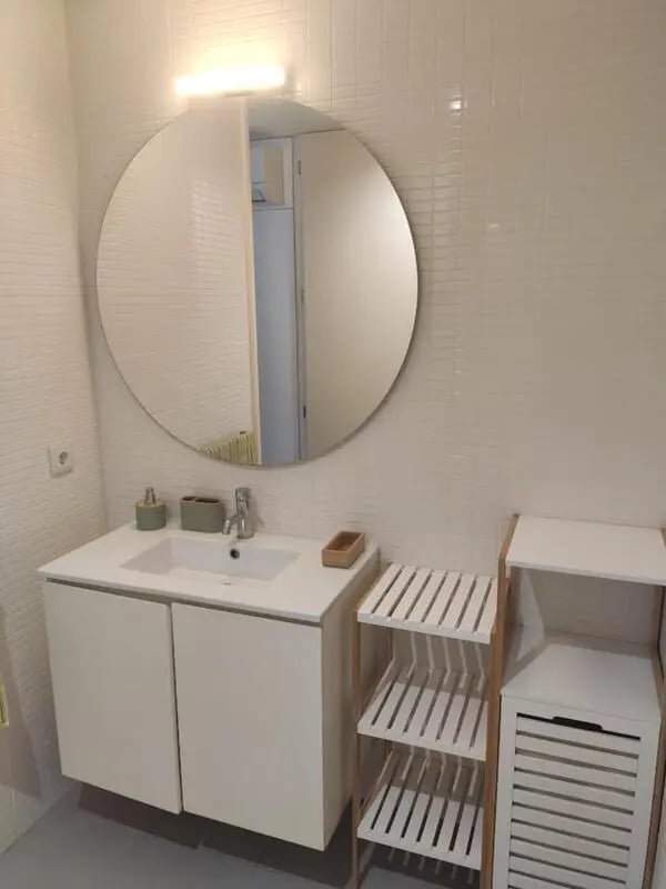Sink vanity mirror shelving unit bathroom at Elegant and functional studio in the historic center of Guimarães in Guimaraes Student Accommodation