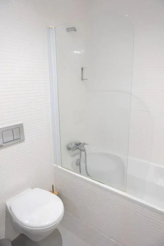 White toilet bath shower screen bathroom at Elegant and functional studio in the historic center of Guimarães in Guimaraes Student Accommodation