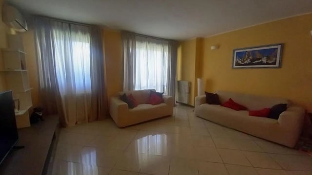 Sofa and chairs with cushions living room at Comfy 3 bedroom apartment close to University of Parma in Parma Student Accommodation
