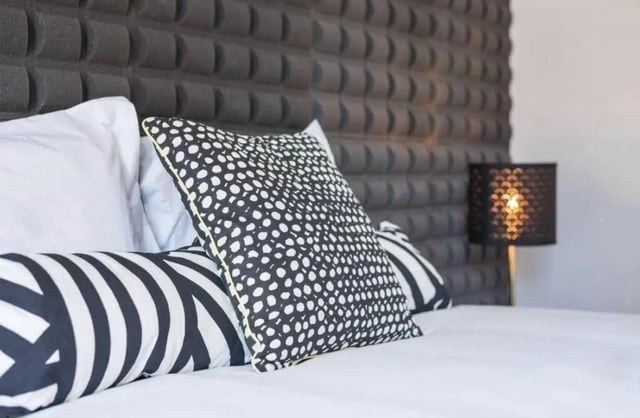 Patterned pillows on bed next to lamp bedroom at Excellent 3-bedroom apartment next to General Torres metro station in Vila Nova De Gaia Student Accommodation
