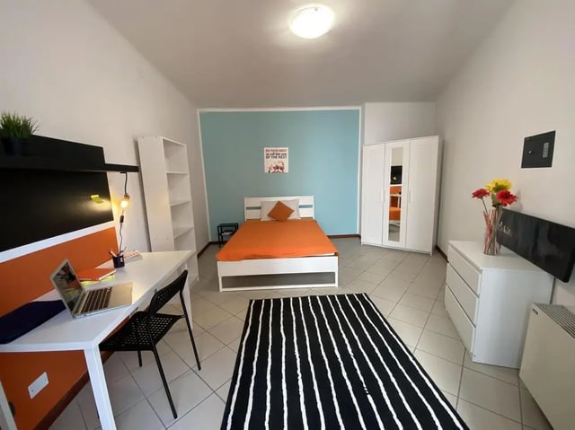 Bed desk wardrobe flowers and rug bedroom at Comfy double bedroom in the heart of Pescara in Pescara Student Accommodation