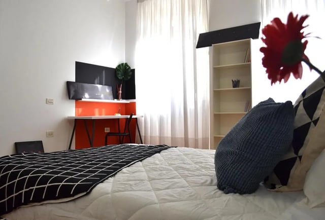 Bed with black throw desk and bookshelf bedroom at Comfy double bedroom in the heart of Pescara in Pescara Student Accommodation