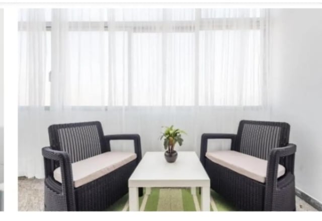 Two chairs and coffee table living area at Excellent 3-bedroom apartment next to General Torres metro station in Vila Nova De Gaia Student Accommodation