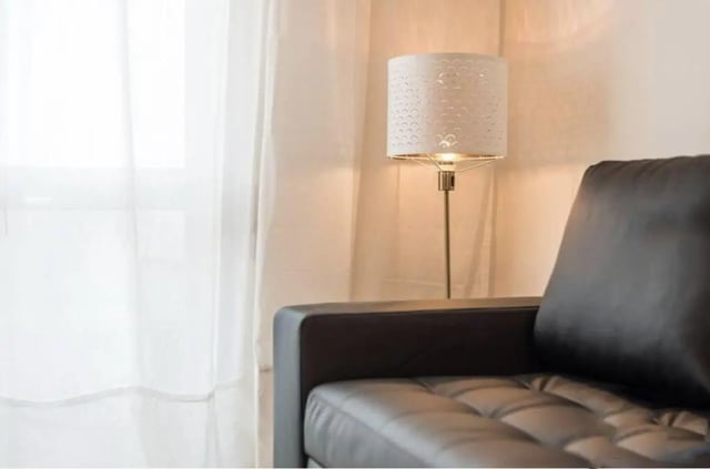 Sofa floor lamp sheer curtains living room at Excellent 3-bedroom apartment next to General Torres metro station in Vila Nova De Gaia Student Accommodation