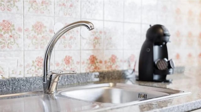 Chrome faucet sink and coffee maker kitchen at Excellent 3-bedroom apartment next to General Torres metro station in Vila Nova De Gaia Student Accommodation