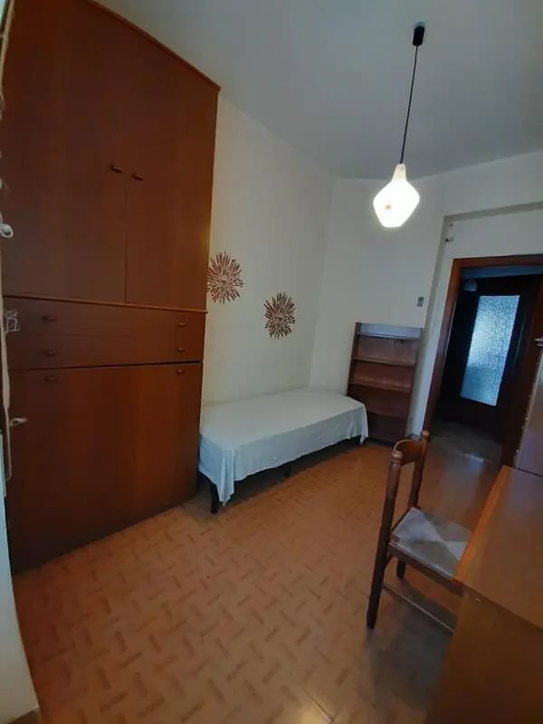 Wooden wardrobe single bed and chair bedroom at Comfy single bedroom near Università degli Studi Mediterranea di Reggio Calabria in Reggio Calabria Student Accommodation