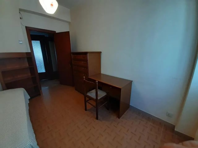 Bed dresser desk chair doorway bookcase bedroom at Comfy single bedroom near Università degli Studi Mediterranea di Reggio Calabria in Reggio Calabria Student Accommodation