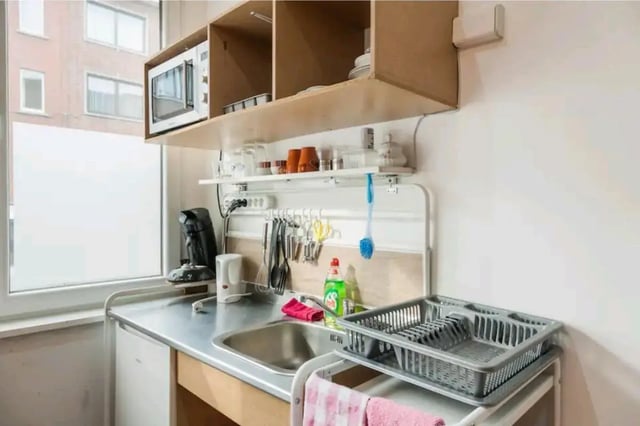 Sink microwave kettle coffee maker dish rack kitchen at Very cosy studio in Berchem in Antwerp Student Accommodation