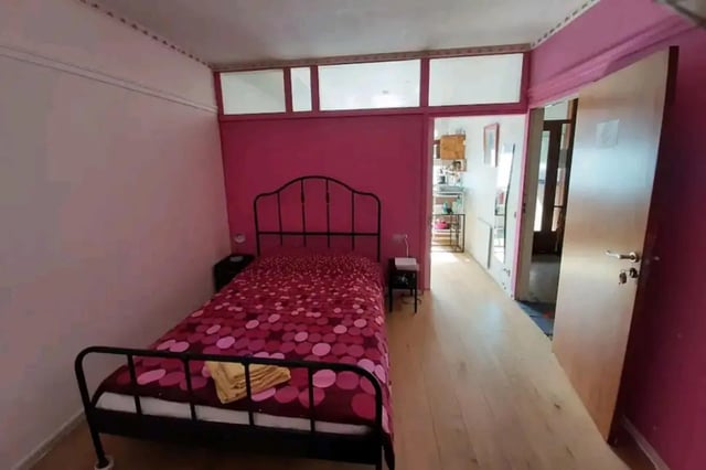 Bed with patterned duvet and bedside table bedroom at Very cosy studio in Berchem in Antwerp Student Accommodation
