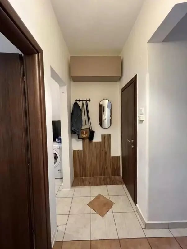 Washing machine coat rack mirror hallway interior at Homely Double Bedroom with a balcony close to Aristotelous Square in Thessaloniki Student Accommodation