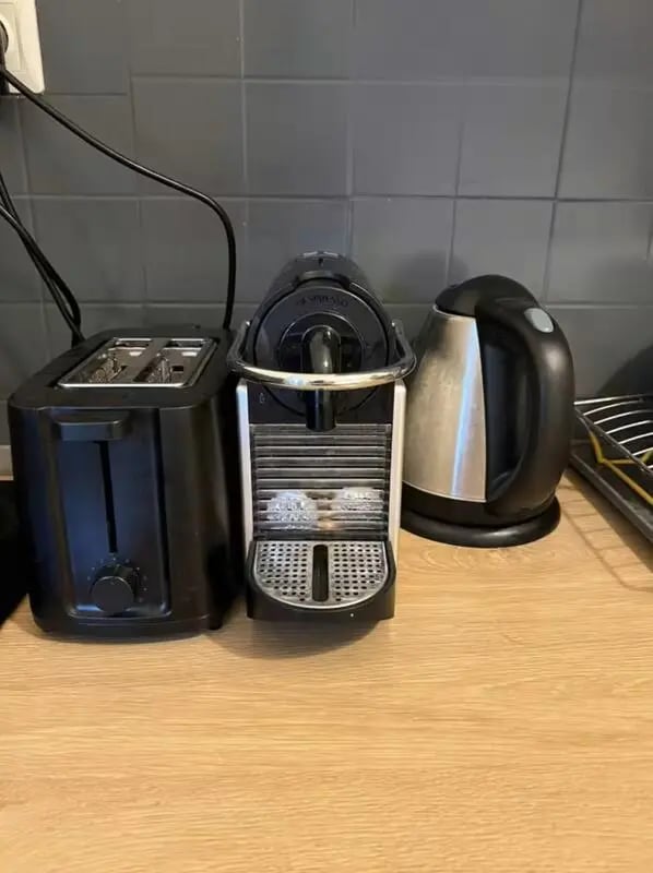 Black toaster coffee maker and kettle kitchen area at Homely Double Bedroom with a balcony close to Aristotelous Square in Thessaloniki Student Accommodation