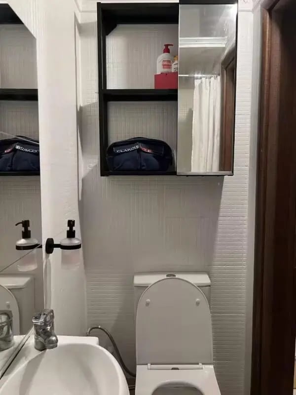 Toilet sink soap dispensers and cabinet bathroom at Homely Double Bedroom with a balcony close to Aristotelous Square in Thessaloniki Student Accommodation