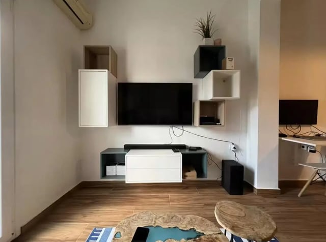 Floating shelves TV stand media console and coffee table living room at Homely Double Bedroom with a balcony close to Aristotelous Square in Thessaloniki Student Accommodation