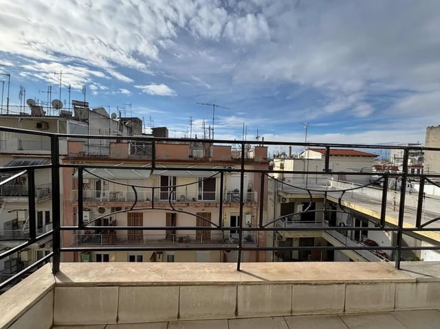 Balcony railing overlooking apartment buildings exterior at Prime location flat with sea view balcony close to Aristotle University in Thessaloniki Student Accommodation