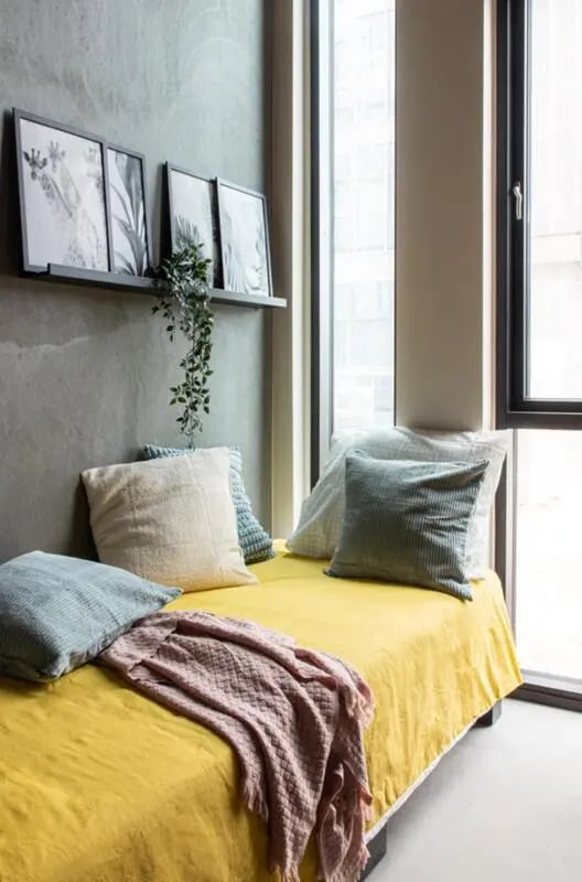 Yellow bed with pillows and framed art bedroom at Cool single ensuite bedroom close to Aarhus Universitet in Aarhus Student Accommodation
