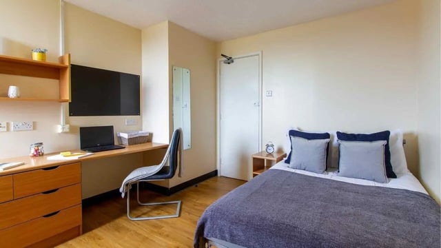 Desk chair laptop and bed student bedroom at Ben Russell Court in Leicester Student Accommodation