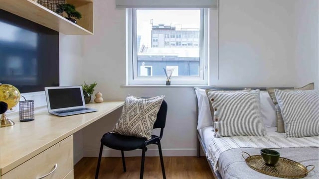 Desk laptop globe bed pillows bedroom at Canalside in Birmingham Student Accommodation