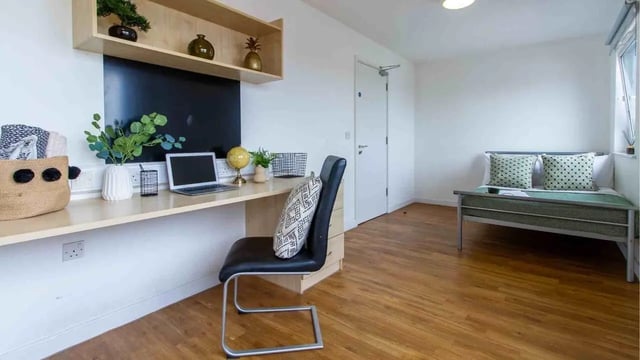 Desk with laptop bed and chair bedroom at Canalside in Birmingham Student Accommodation