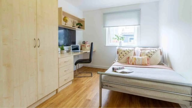 Bed desk wardrobe pillows window bedroom at Canalside in Birmingham Student Accommodation